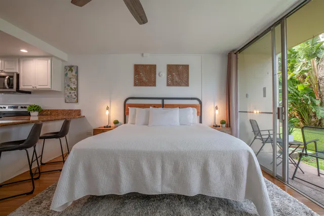 a bedroom with a bed and lamp next to a window