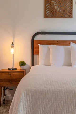 a bedroom with a bed and ceiling fan