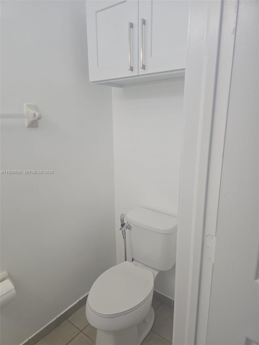 3399 West 90th Terrace Hialeah, FL 33018 - Photo 19 of 59 a white toilet sitting next to a sink