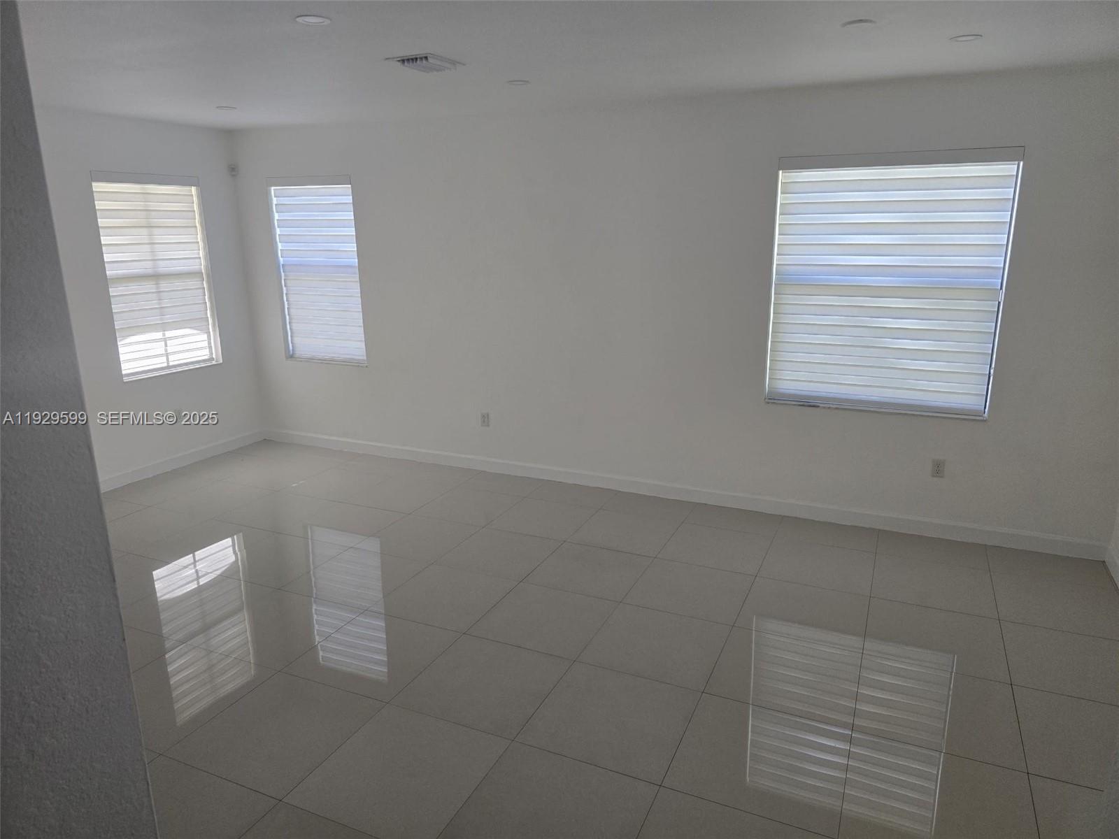 3399 West 90th Terrace Hialeah, FL 33018 - Photo 24 of 59 an empty room with windows