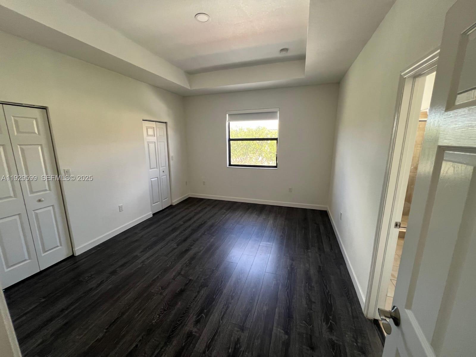 3399 West 90th Terrace Hialeah, FL 33018 - Photo 25 of 59 a view of a hallway with wooden floor and staircase