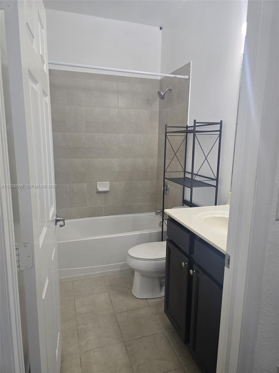 3399 West 90th Terrace Hialeah, FL 33018 - Photo 26 of 59 a bathroom with a granite countertop bathtub shower sink vanity and toilet