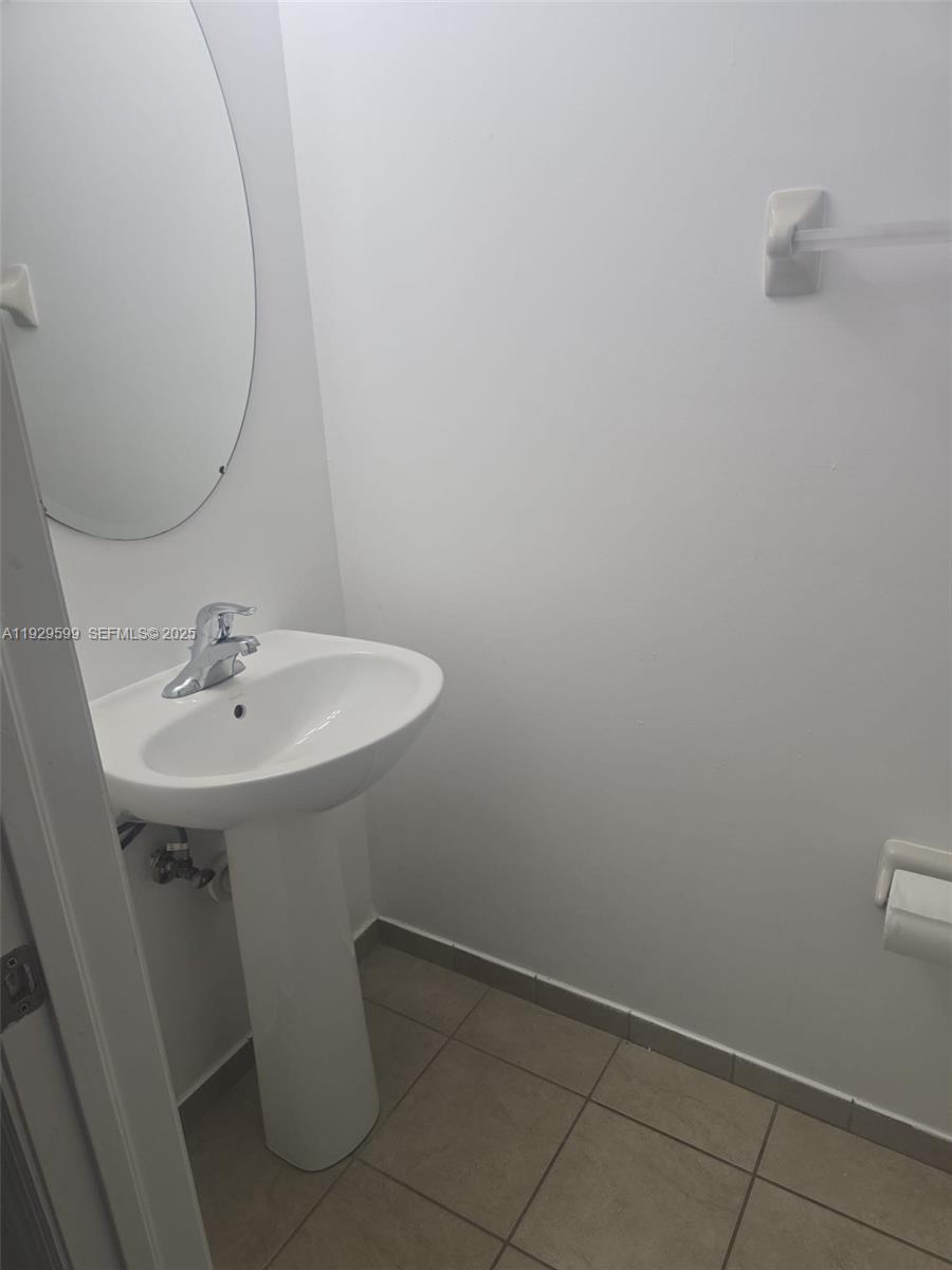 3399 West 90th Terrace Hialeah, FL 33018 - Photo 28 of 59 a bathroom with a sink and mirror