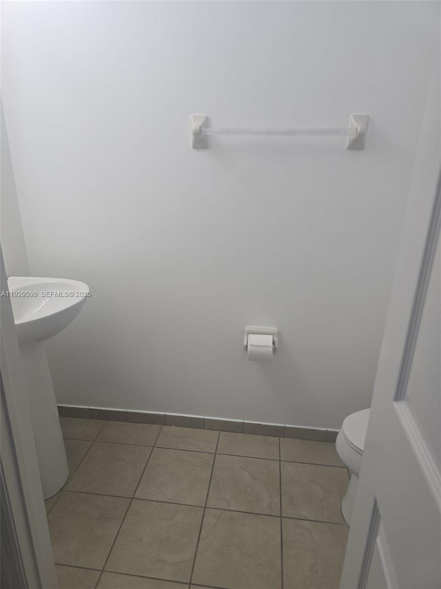 3399 West 90th Terrace Hialeah, FL 33018 - Photo 31 of 59 a bathroom with a sink and toilet