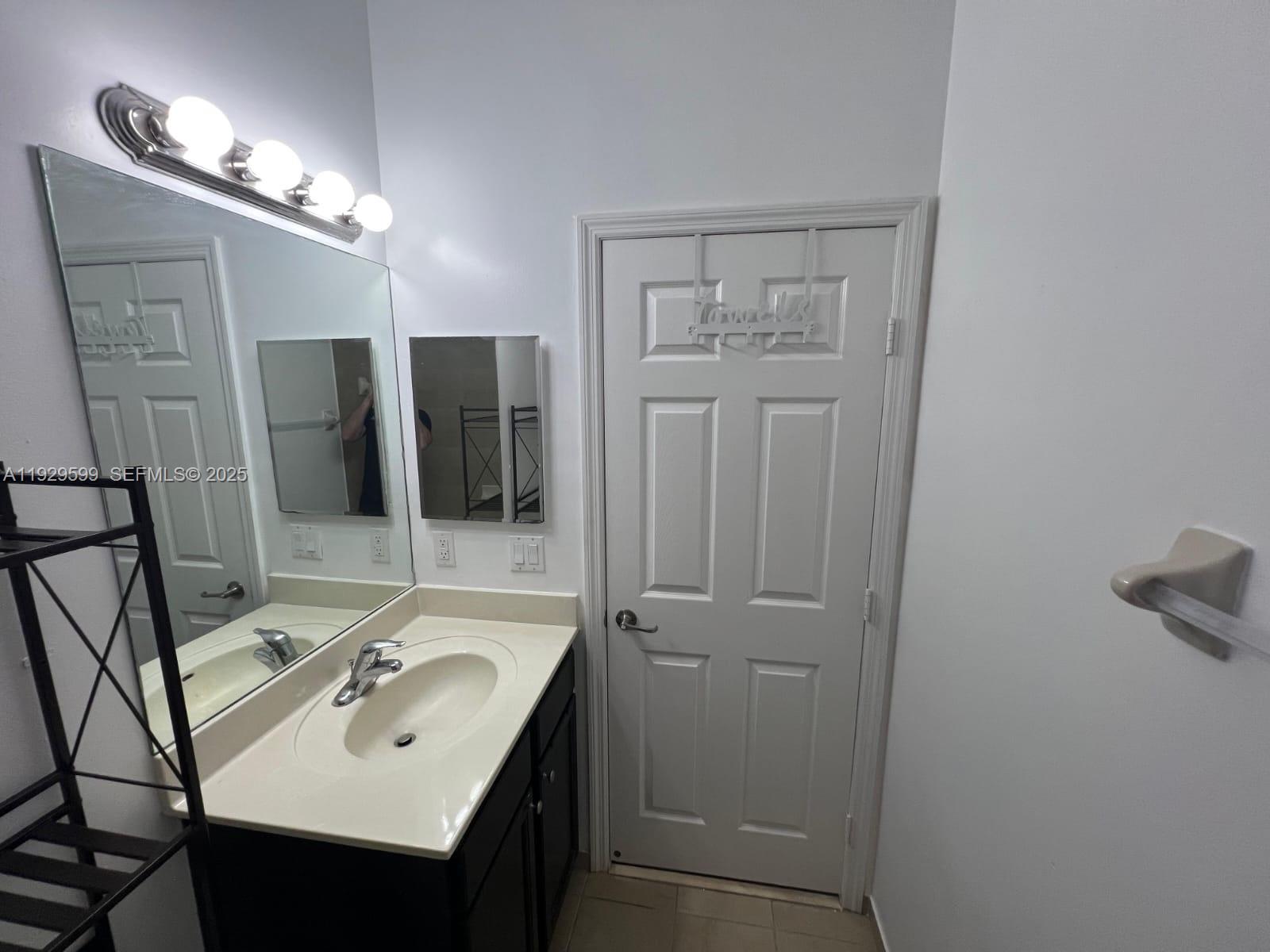 3399 West 90th Terrace Hialeah, FL 33018 - Photo 34 of 59 a bathroom with a sink and a mirror