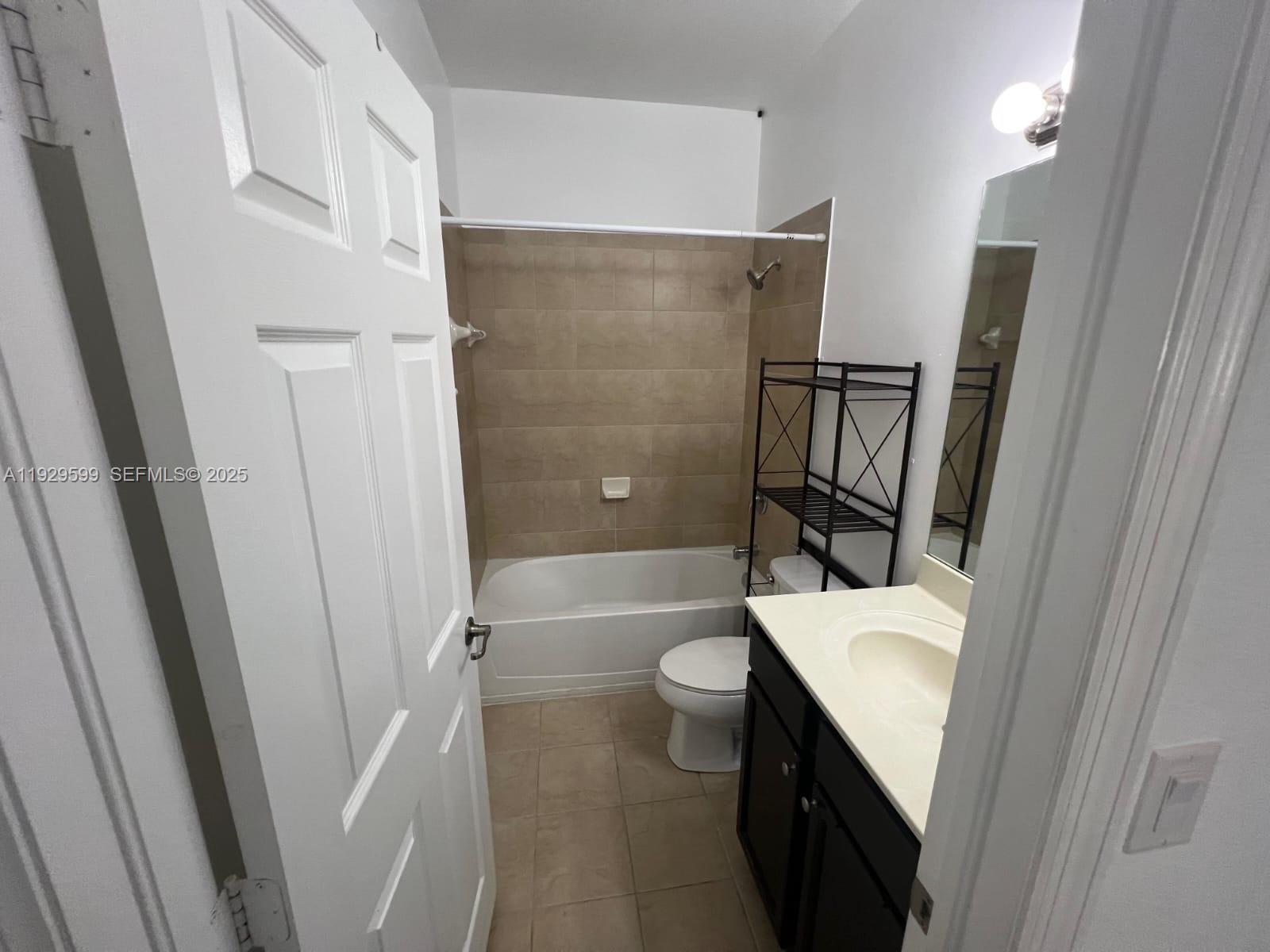 3399 West 90th Terrace Hialeah, FL 33018 - Photo 36 of 59 a bathroom with a sink a toilet a mirror and shower