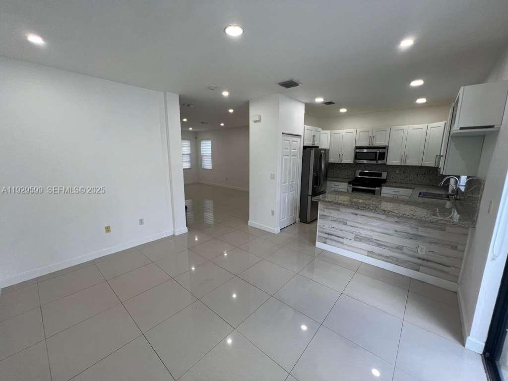 3399 West 90th Terrace Hialeah, FL 33018 - Photo 7 of 59 a view of kitchen with refrigerator and window