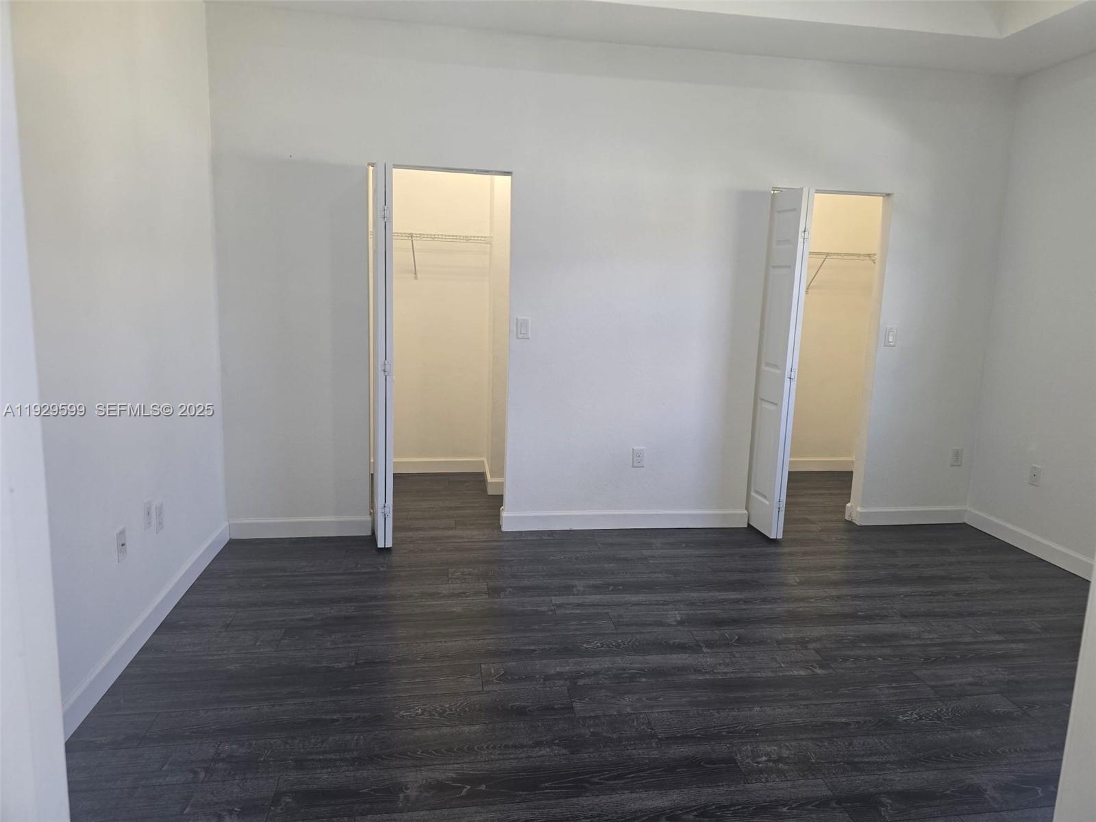 3399 West 90th Terrace Hialeah, FL 33018 - Photo 8 of 59 a view of an empty room with wooden floor and a window