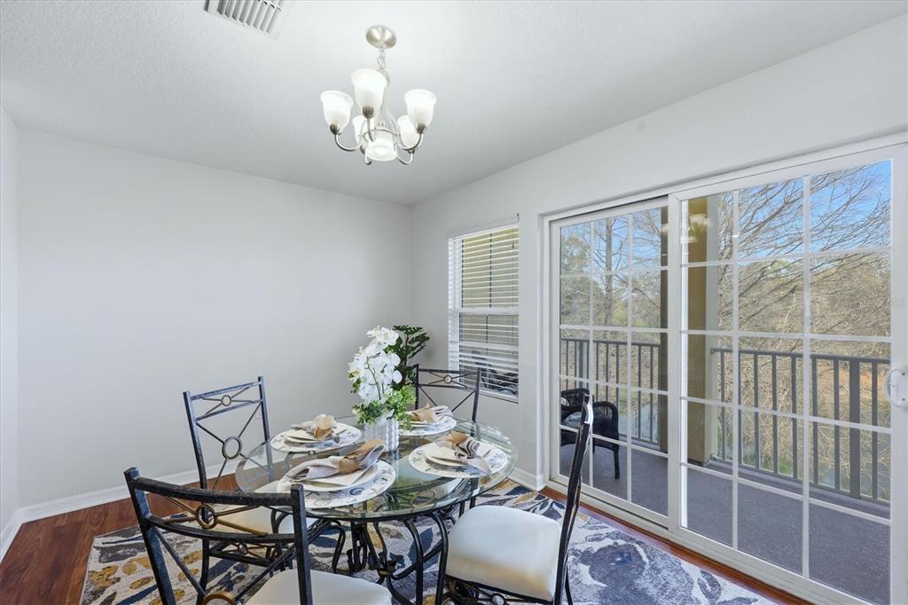 9038 White Sage Loop Lakewood Ranch, FL 34202 - Photo 12 of 52 a view of a dining room with furniture window and outside view