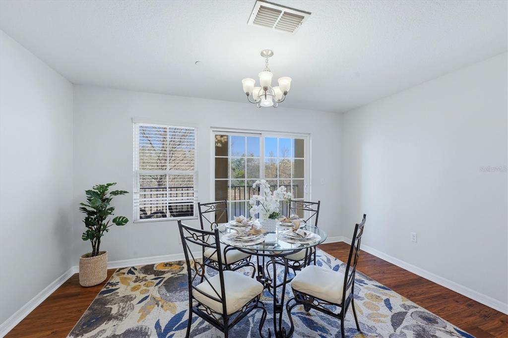 9038 White Sage Loop Lakewood Ranch, FL 34202 - Photo 15 of 52 a view of a dining room with furniture window and wooden floor