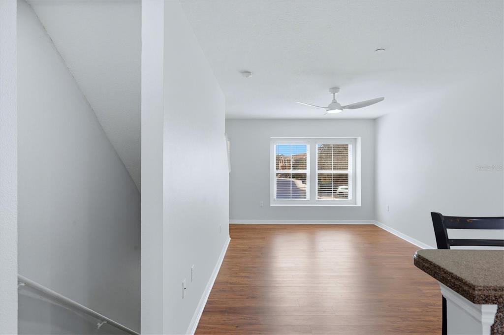 9038 White Sage Loop Lakewood Ranch, FL 34202 - Photo 18 of 52 a view of an empty room with wooden floor and a window