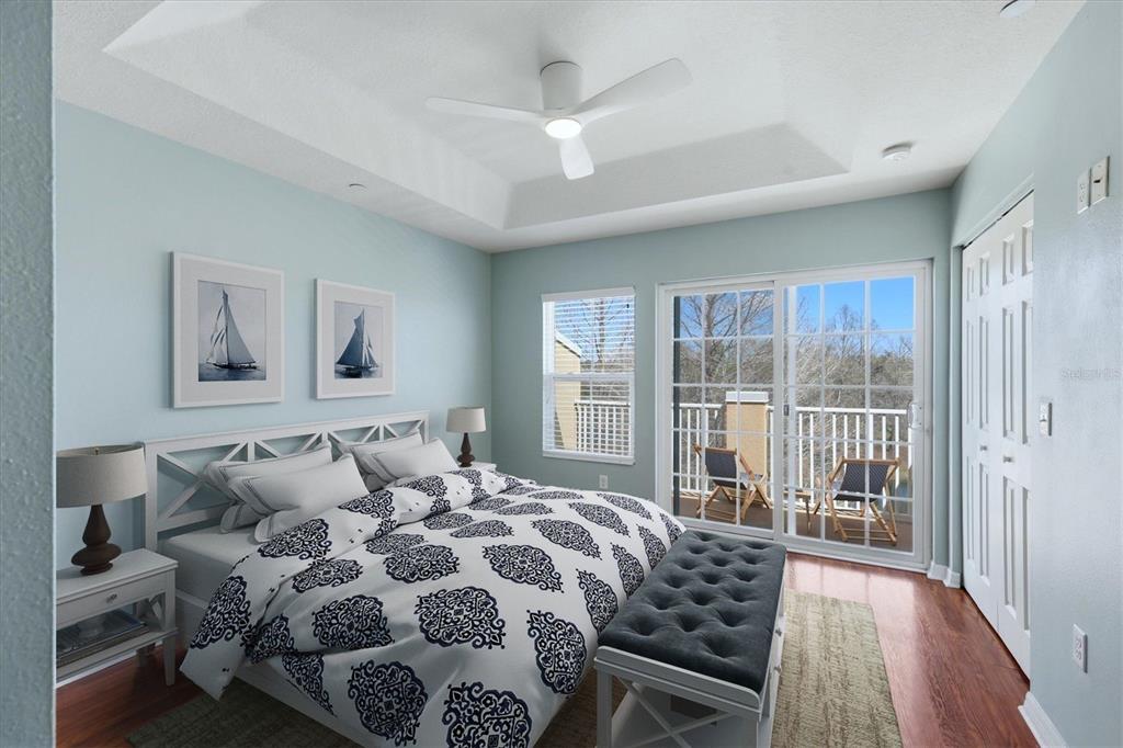 9038 White Sage Loop Lakewood Ranch, FL 34202 - Photo 20 of 52 a bedroom with a large bed and a large window