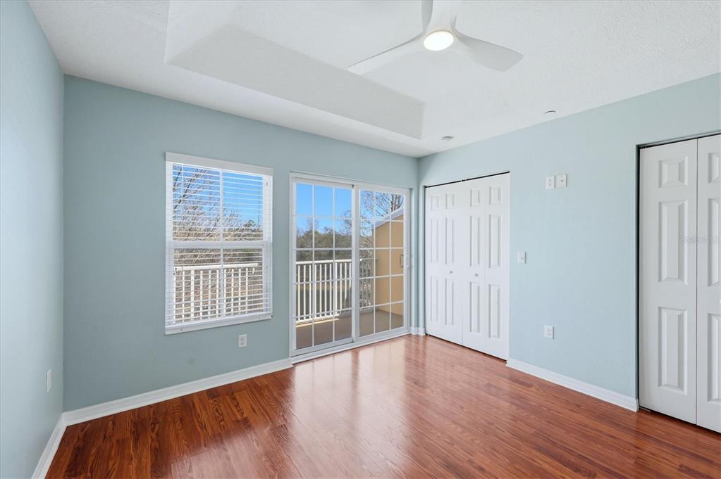 9038 White Sage Loop Lakewood Ranch, FL 34202 - Photo 21 of 52 an empty room with wooden floor and windows