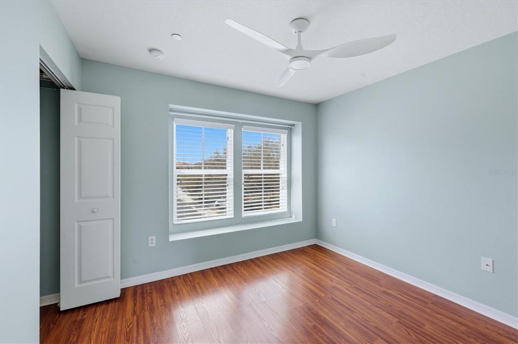 9038 White Sage Loop Lakewood Ranch, FL 34202 - Photo 26 of 52 a view of an empty room with wooden floor and a window