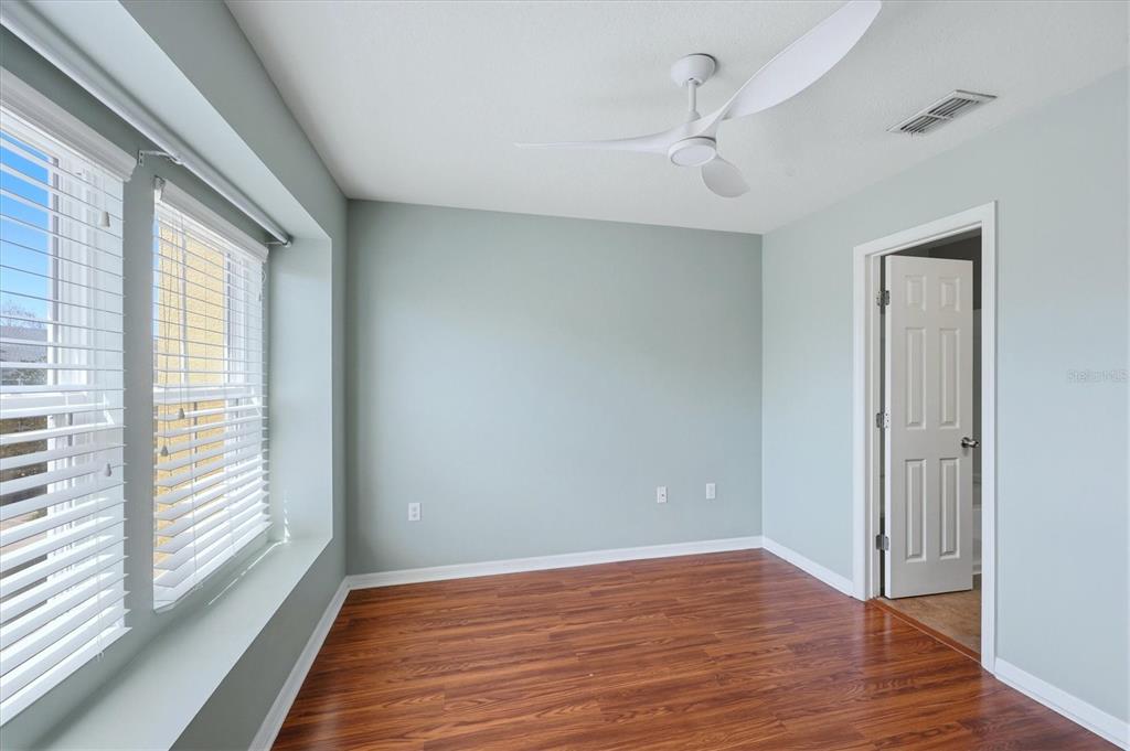 9038 White Sage Loop Lakewood Ranch, FL 34202 - Photo 27 of 52 a view of an empty room with wooden floor and a window