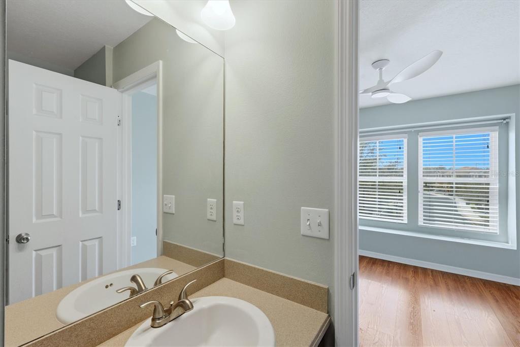9038 White Sage Loop Lakewood Ranch, FL 34202 - Photo 30 of 52 a bathroom with a granite countertop tub sink and mirror