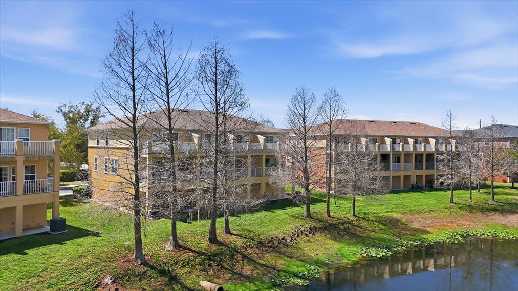 9038 White Sage Loop Lakewood Ranch, FL 34202 - Photo 43 of 52 a view of a residential apartment building with a yard