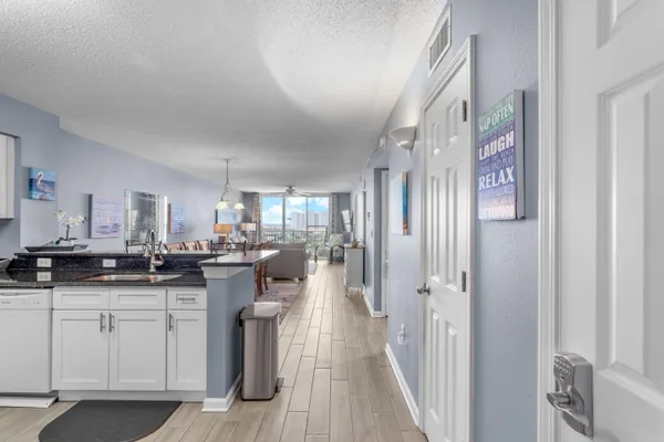 a kitchen with granite countertop a sink and cabinets
