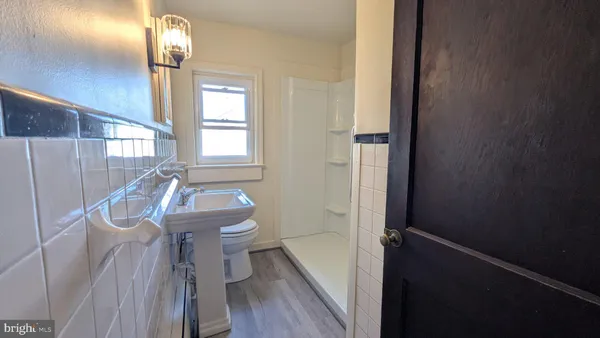 a bathroom with a sink a toilet and tub