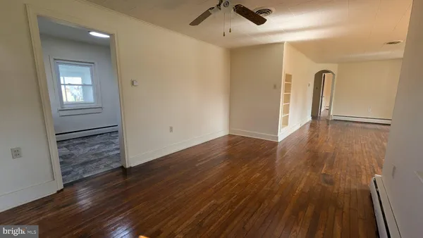 wooden floor in an empty room with a window