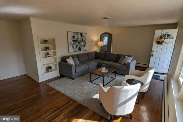 a living room with furniture and wooden floor