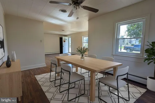 a view of a dining room with furniture and window