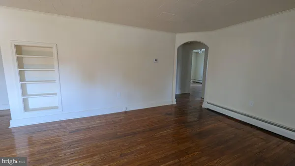 an empty room with wooden floor and closet