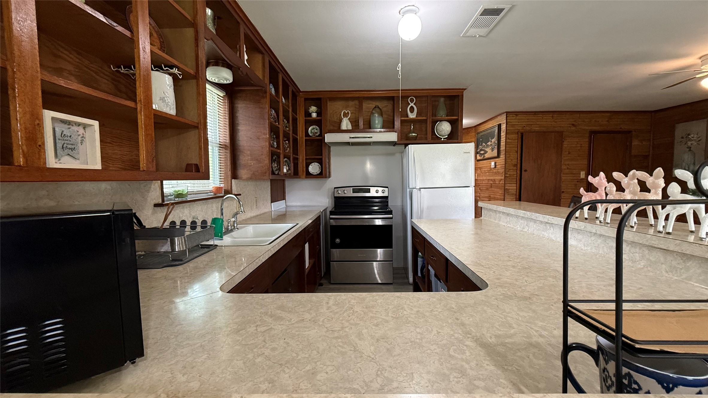 215 Weldon Livingston, TX 77351 - Photo 12 of 22 a kitchen with stainless steel appliances granite countertop a refrigerator a stove and a sink with wooden floor
