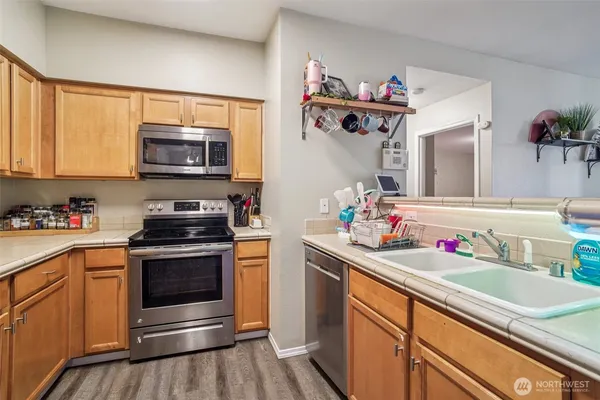 a kitchen with stainless steel appliances granite countertop a stove and a microwave