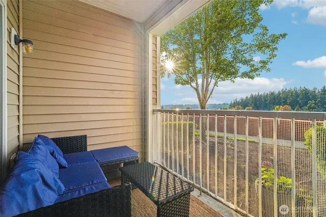 a view of a white house with a yard and potted plants