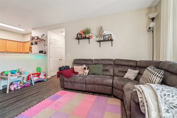 a living room with furniture gym equipment and a large window