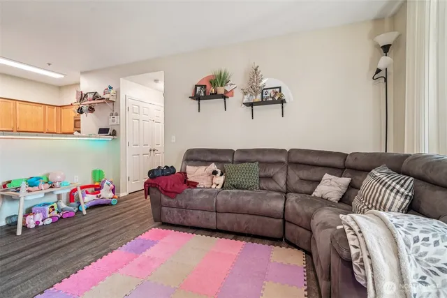 a living room with furniture gym equipment and a large window