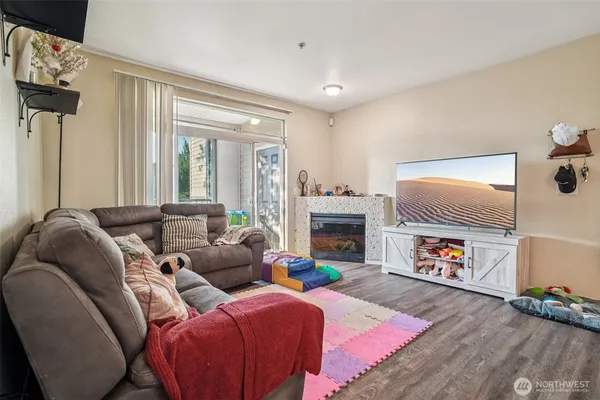 a living room with furniture a dining table and chairs with wooden floor