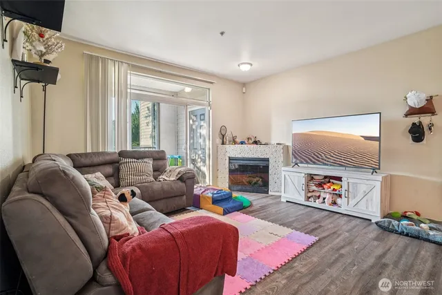 a living room with furniture a dining table and chairs with wooden floor