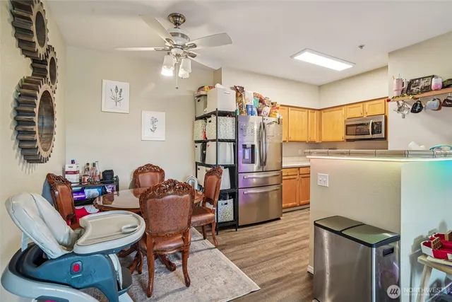 a dining room with furniture and chandelier fan