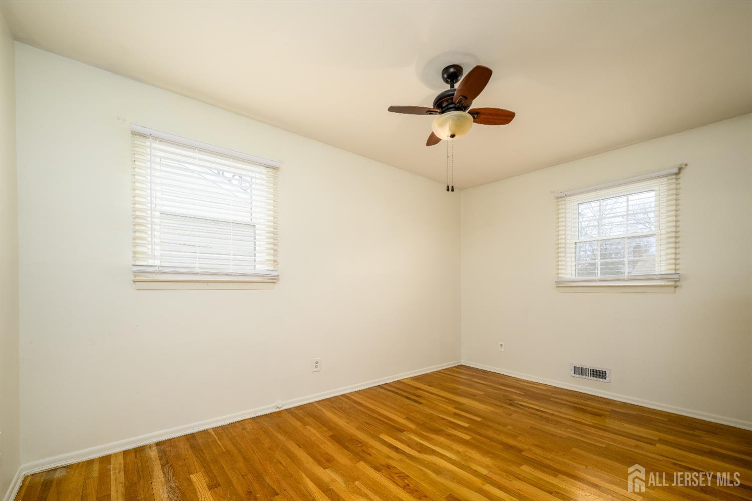 178 Grant Avenue Colonia, NJ 07067 - Photo 22 of 39 a view of empty room with wooden floor and fan