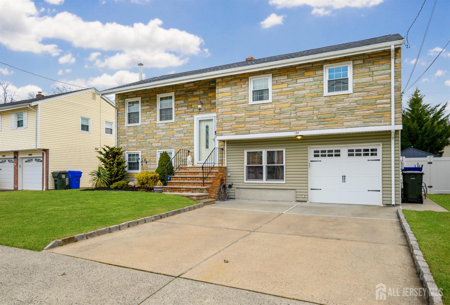 178 Grant Avenue Colonia, NJ 07067 - Photo 35 of 39 a front view of a house with a yard and garage