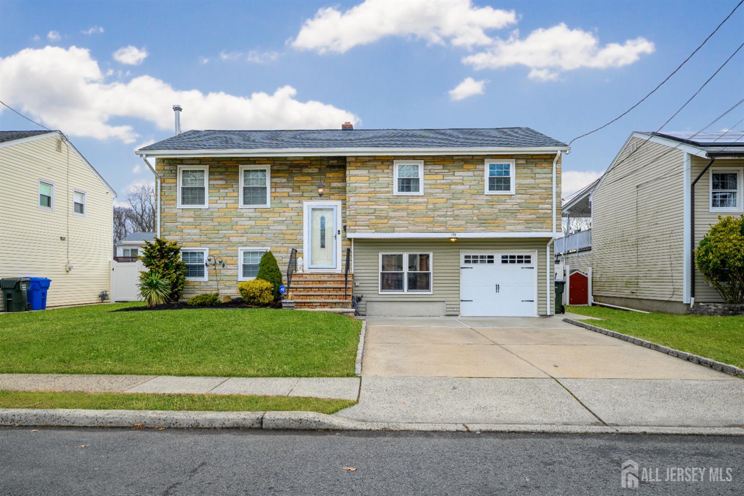 178 Grant Avenue Colonia, NJ 07067 - Photo 36 of 39 a front view of a house with a yard and garage