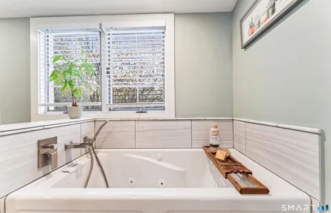 a bathroom with a bathtub and a window