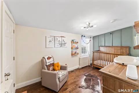a bedroom with furniture and a rug