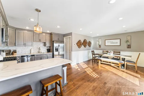 a living room with stainless steel appliances kitchen island granite countertop furniture and a kitchen view