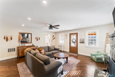 a living room with furniture and wooden floor