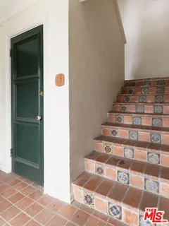 a view of entryway with bathroom and front door