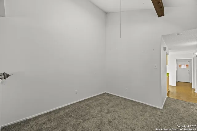 an empty room with closet and mirror