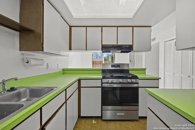 a kitchen with a stove and a sink