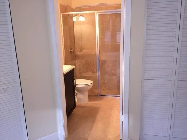 a bathroom with a toilet and a shower