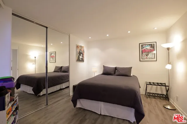 a bedroom with a bed and a mirror