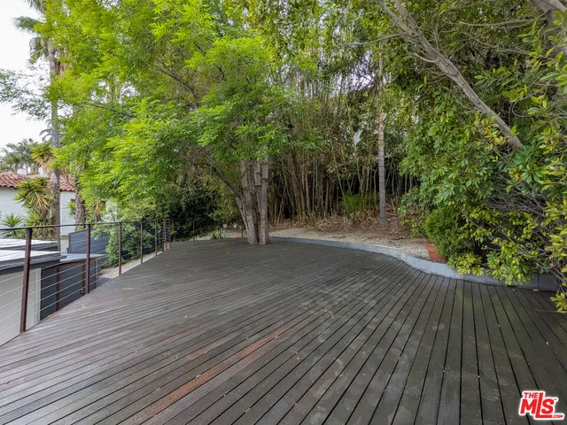 a view of outdoor space and deck with large trees