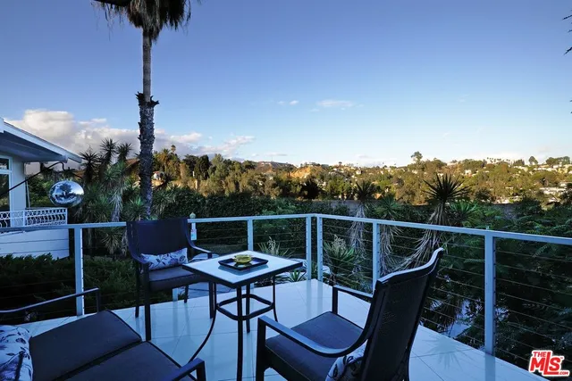 a terrace with outdoor seating and city view