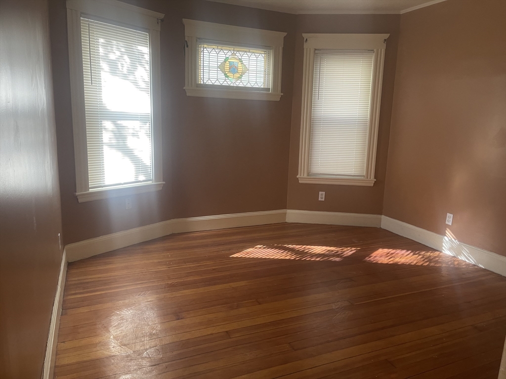 6 Bailey Street, Unit 1 Boston, MA 02124 - Photo 4 of 12 a view of empty room with wooden floor and fan